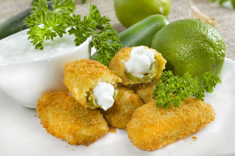 Mexican-american jalapeno poppers served with lime . Mexican-american jalapeno poppers served with lime .