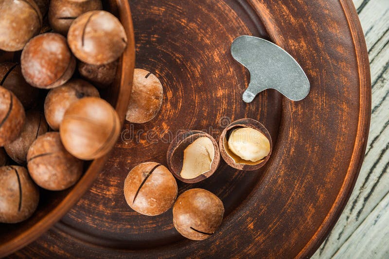 Macedonian Nuts on a Wooden Plate on the Background of a Textural Wooden Table. Macedonian Nuts