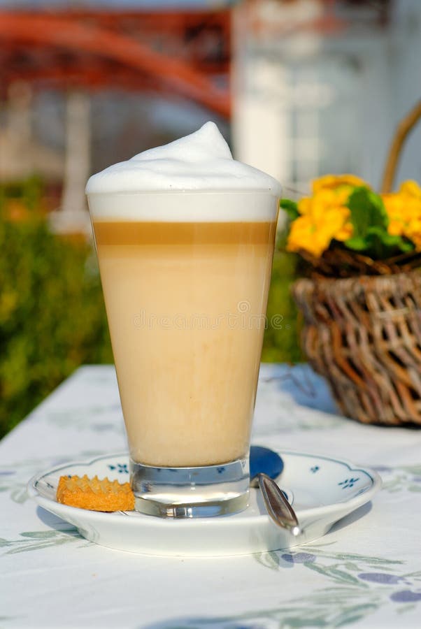A glass of coffee on a table outdoor. A glass of coffee on a table outdoor