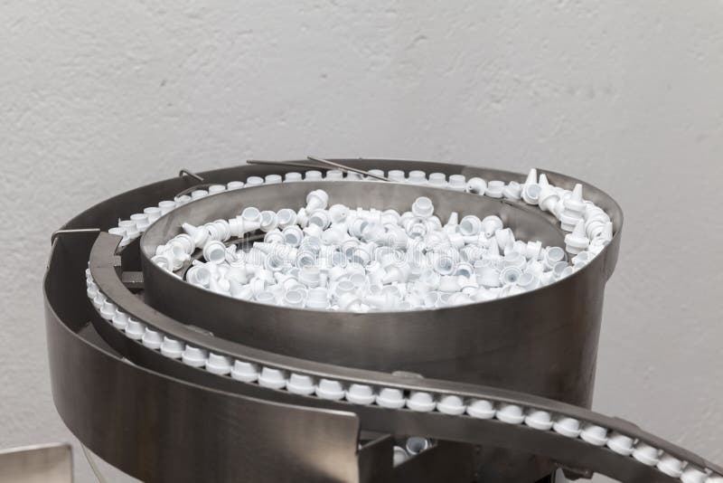 Machine for automatically placing plastic lids stock photography