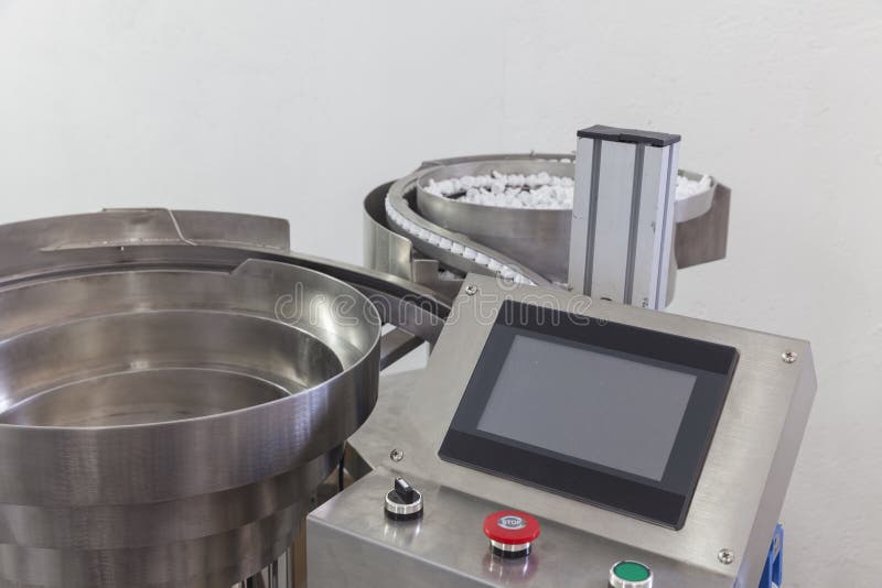 Machine for automatically placing plastic lids stock photo