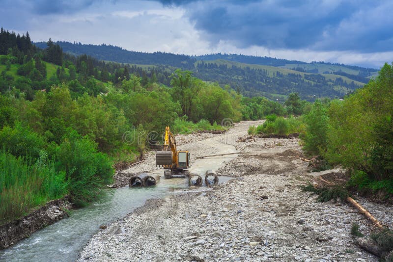 Machine building a small bridge stock photos