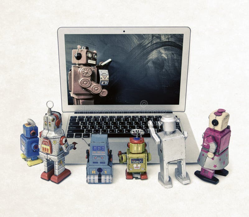 Machine learning concept with retro robots at a laptop computer royalty free stock images Machine learning concept with retro robots at a laptop computer royalty free stock images