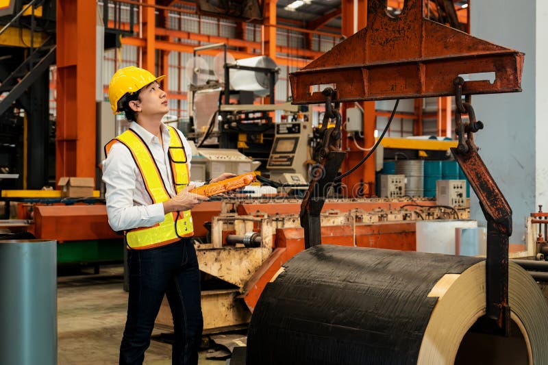 Machine operator skillfully operate steel forming machinery. Exemplifying stock photo