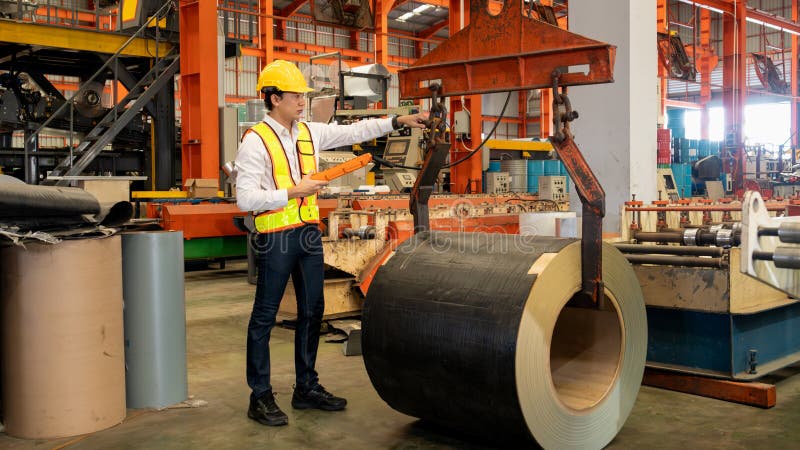 Machine operator skillfully operate steel forming machinery. Exemplifying royalty free stock images