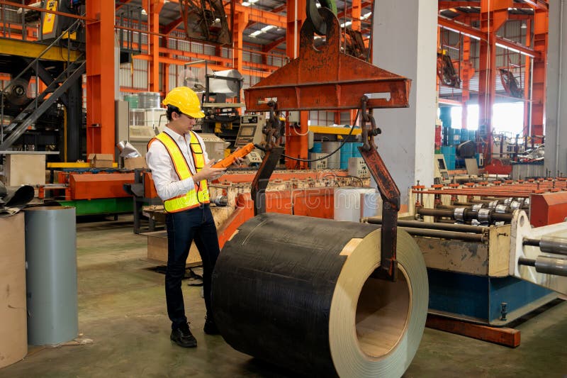 Machine operator skillfully operate steel forming machinery. Exemplifying stock image