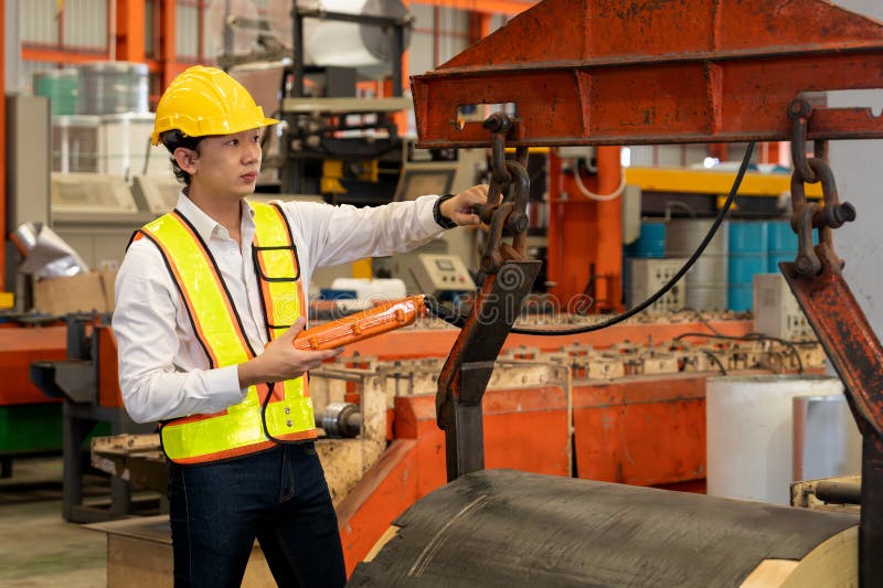 Machine operator skillfully operate steel forming machinery. Exemplifying stock photography