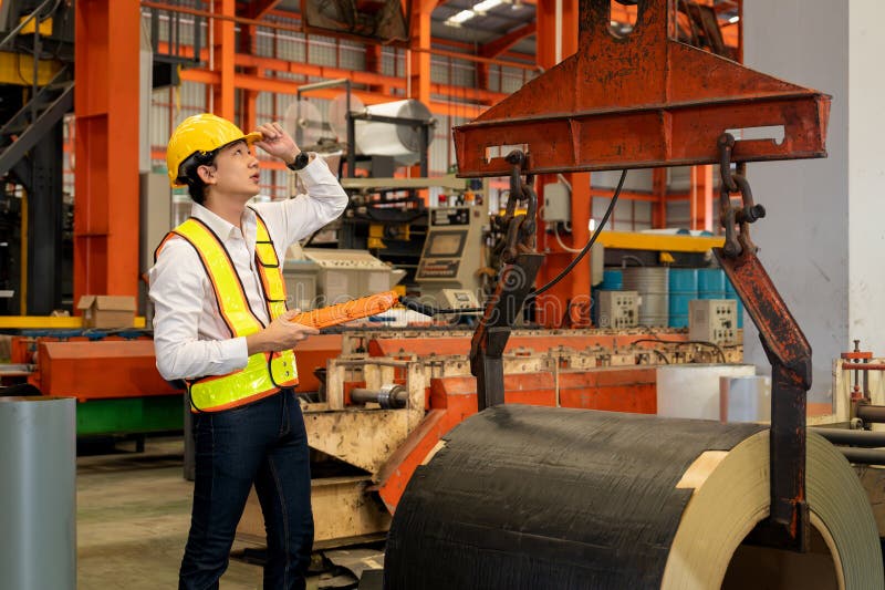 Machine operator skillfully operate steel forming machinery. Exemplifying stock photo
