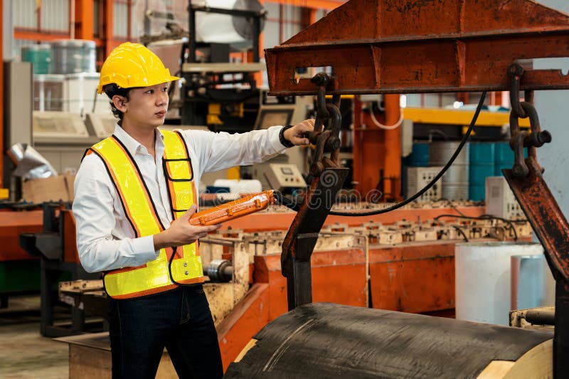 Machine operator skillfully operate steel forming machinery. Exemplifying stock photo