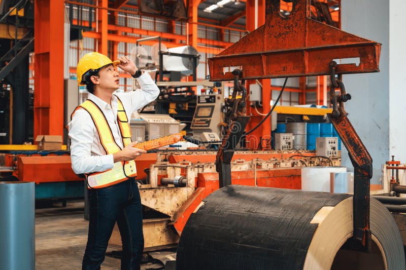Machine operator skillfully operate steel forming machinery. Exemplifying stock photo