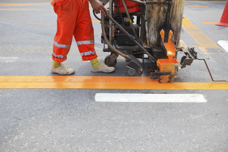 Machine and worker at road construction