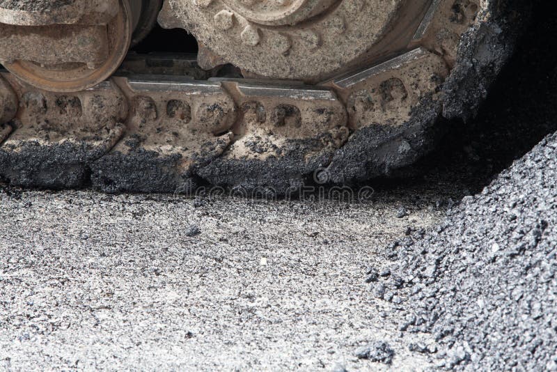 Machines are pouring asphalt stock images
