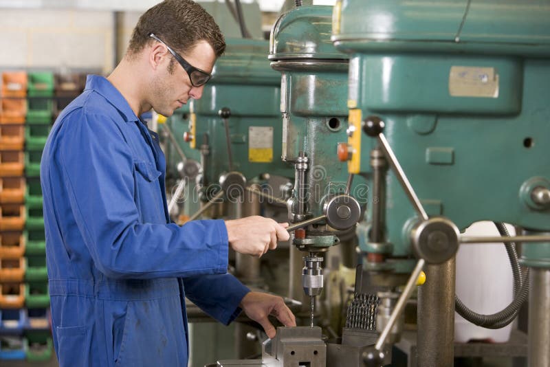 Machinist working on machine royalty free stock photography