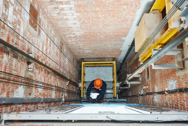 Machinists Adjusting Lift in Elevator Hoist Way Stock Image Image of
