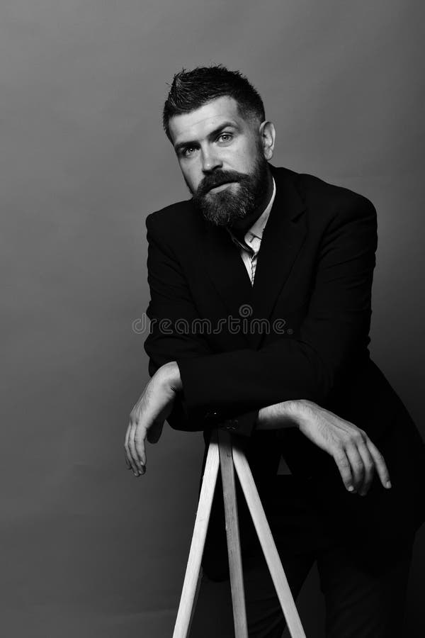 Man with beard wearing classic suit. Photography and profession concept