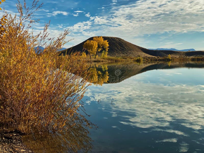 Mack Mesa Long View of Autumn Reflections. Highline Lake State Park in Western Colorado is fine for outdoor recreation and wildlife viewing. Includes a smaller stock photography Mack Mesa Long View of Autumn Reflections. Highline Lake State Park in Western Colorado is fine for outdoor recreation and wildlife viewing. Includes a smaller stock photography