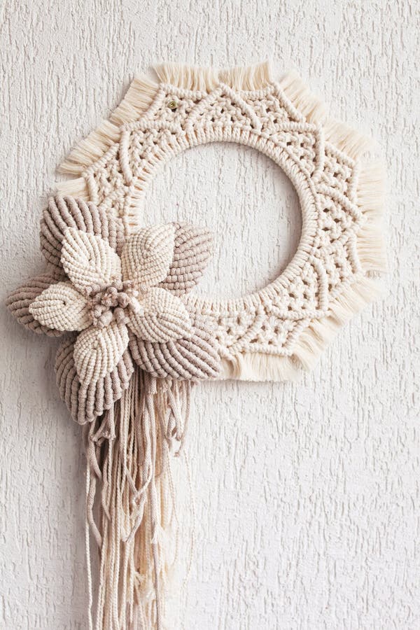 Macrame Wreath with Big Cotton Flower on a White Decorative Plaster