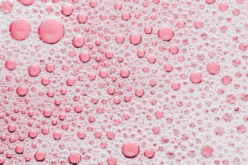 Macro bubble of pink water background, transparent bath soap