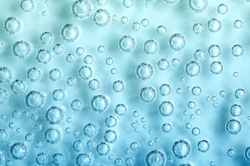 Macro Carbon dioxide CO2 bubbles in water on a blue background