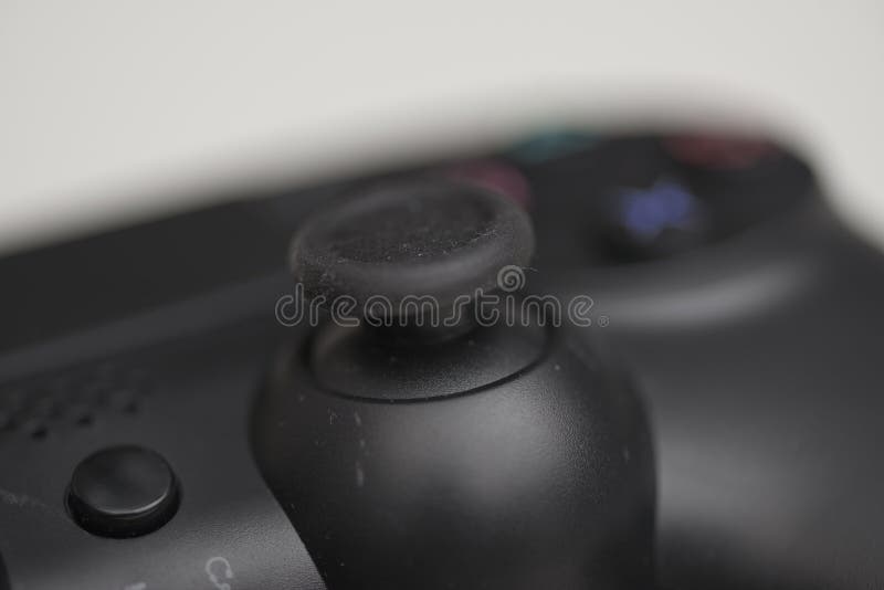 Macro close up of black game controller analog joystick isolated on light background for gaming use royalty free stock photos
