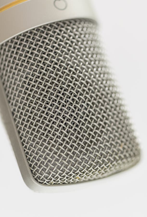 Close-Up of Studio Microphone Metal Mesh Grille Showing Fine Detail and Texture for Audio Recording and Podcast Themes stock photo
