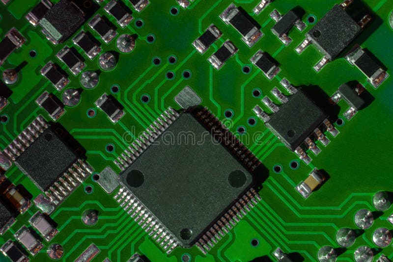 Macro close-up shot of green circuit board, computer motherboard Components: microcircuits, processor, transistors, semiconductors stock photo