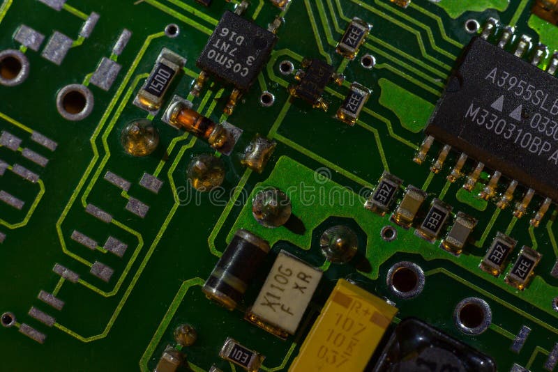 Macro close-up shot of green circuit board, computer motherboard Components: microcircuits, processor, transistors, semiconductors royalty free stock image