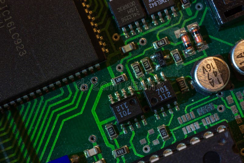 Macro close-up shot of green circuit board, computer motherboard Components: microcircuits, processor, transistors, semiconductors royalty free stock photo