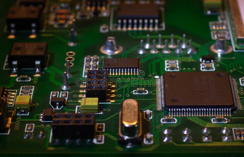 Macro close-up shot of green circuit board, computer motherboard Components: microcircuits, processor, transistors, semiconductors stock photos