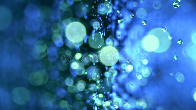 Macro close up super slow motion 1000 fps. Splash drops liquid in blue color. Intense movement of splashes and drops