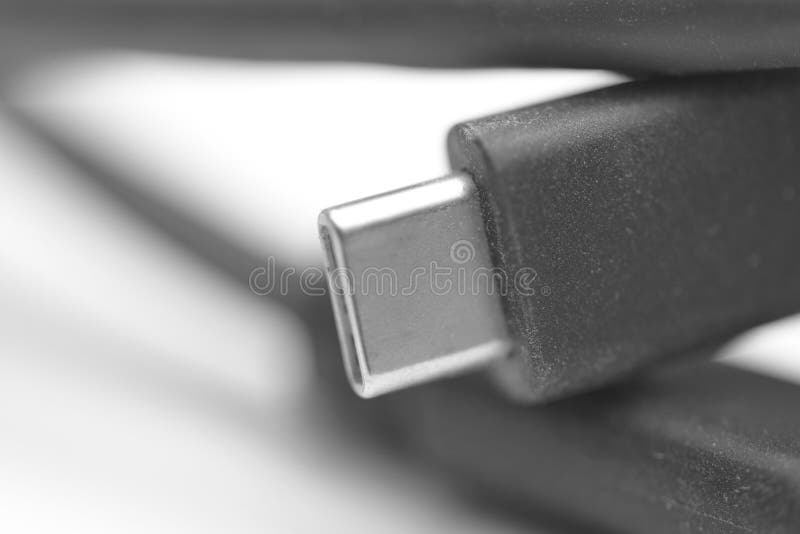High-detail macro photograph of a USB-C connector on a black cable, showcasing the sleek metal plug and textured cable housing. The image highlights modern connectivity technology used for fast charging, data transfer, and universal compatibility across smartphones, laptops, tablets, and electronic devices. Ideal for tech themes, digital lifestyle, accessories, and connectivity solutions. Usb data transfer stock images, royalty-free photos and pictures