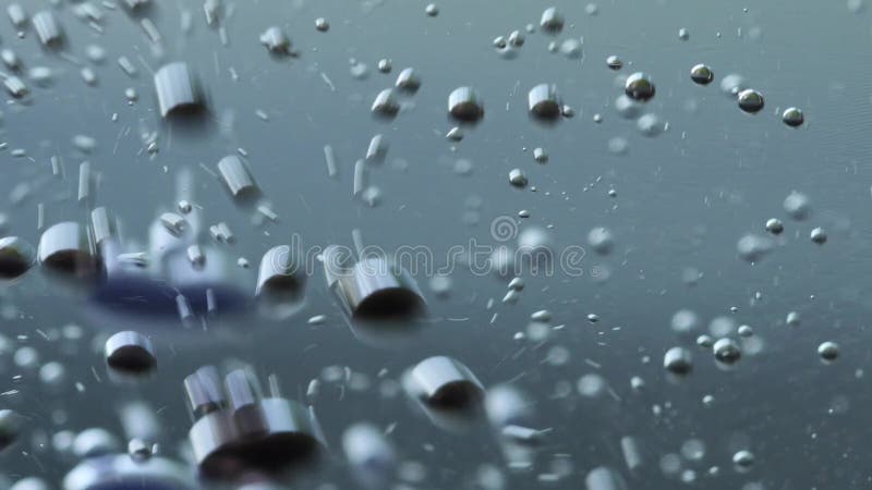 Macro closeup of an elements in water or oil, abstract background. 4K UHD.