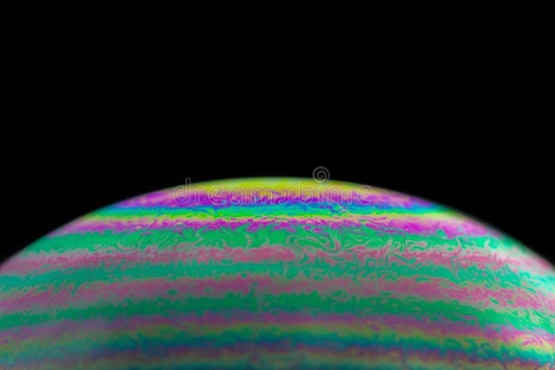 Macro colorful abstract soap bubble on black background stock image