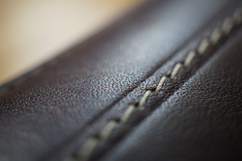 Macro Detail Of A White Thread Stitching Black And Brown Stitched