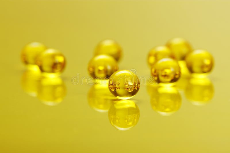 Macro of E Vitamin Capsules on Yellow Stock Photo Image of shape