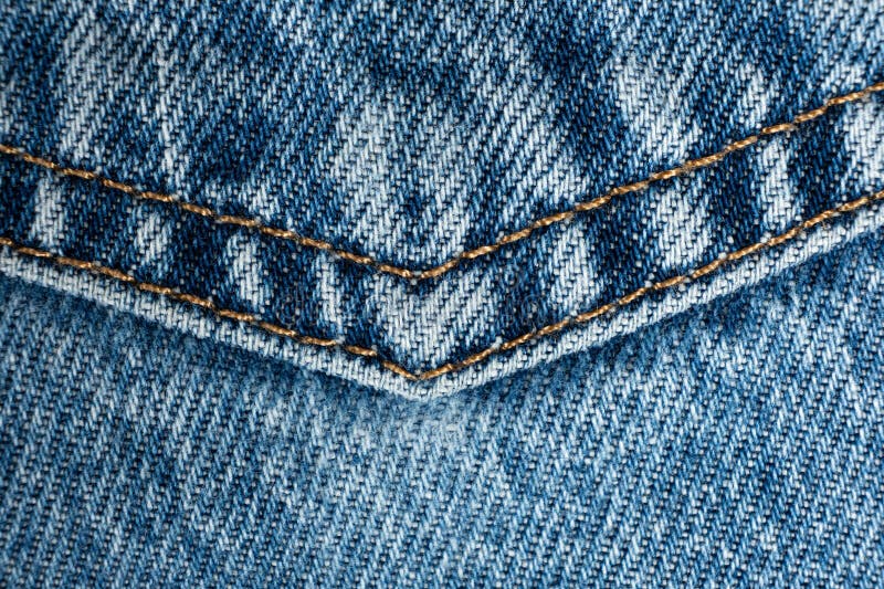 Macro fabric texture of cotton blue jeans. Pocket and thread stitching royalty free stock image