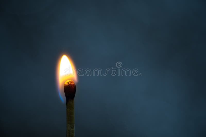 Macro fire burning on matchstick. Metaphor for ideas and inspiration