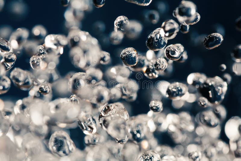 Macro of levitation of water drops on blue