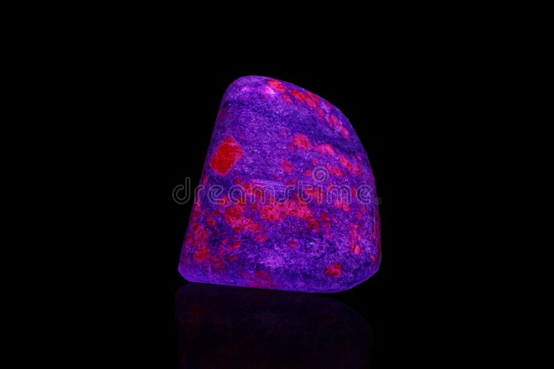 Macro Mineral Stone Ruby Under Ultraviolet Light on a Black Background Stock Photo Image of