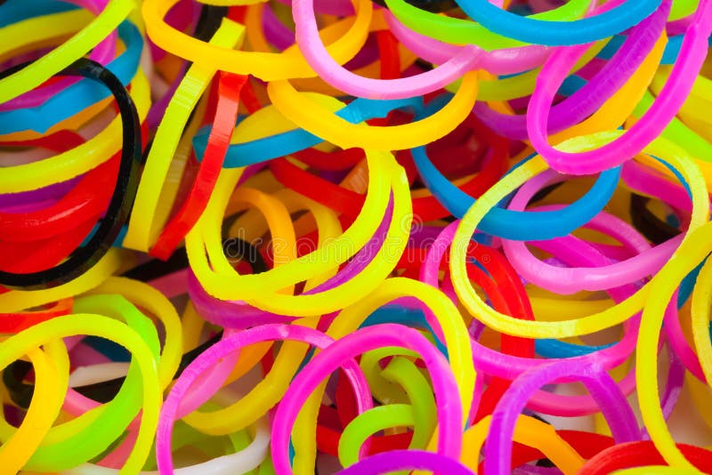 Premium Photo  Pile of small round colorful rubber bands for making  rainbow loom bracelets isolated on dark background