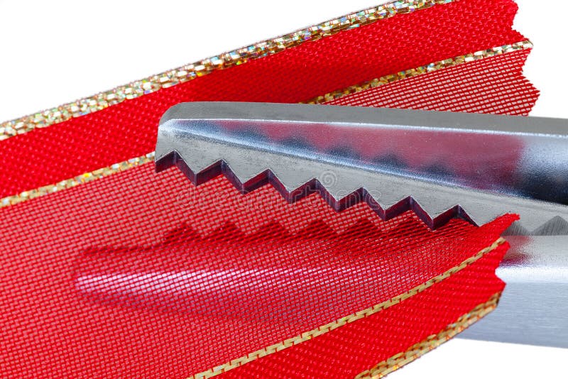 Macro pinking shears or scissors on red ribbon