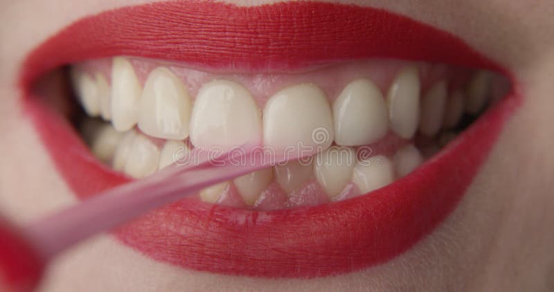 Macro of Red Lips Chewing a Pink Bubble Gum and Smiling
