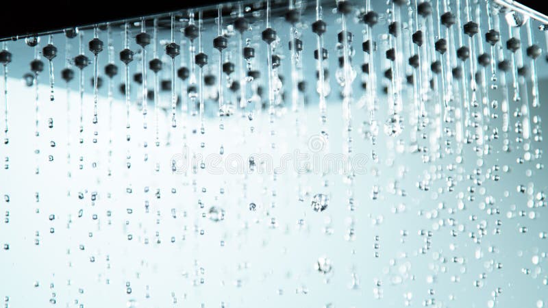 Macro shot of dripping water drops from shower head