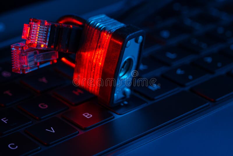 Macro shot of lock on a laptop keyboard with neon lights. Close-up view. Concept of modern technology. Equipment protection..