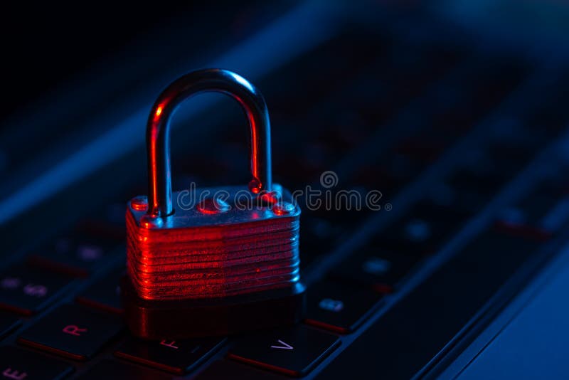 Macro shot of lock on a laptop keyboard with neon lights. Close-up view. Concept of modern technology. Secure payment.