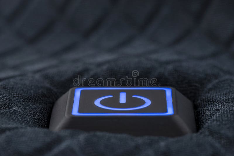 Macro shot of a plastic button with a blue power symbol, sewn into modern clothing. Macro shot of a plastic button with a blue power symbol, sewn into modern clothing