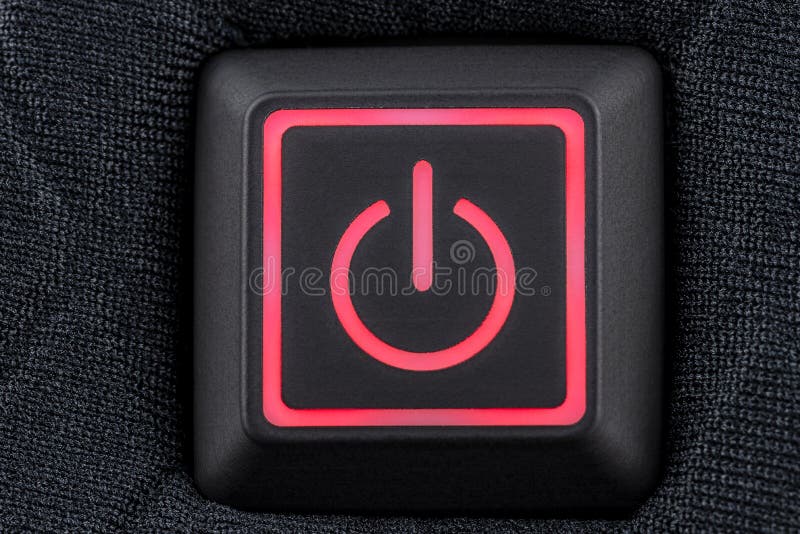 Macro shot of a plastic button with a red power symbol, sewn into modern clothing, top view. Macro shot of a plastic button with a red power symbol, sewn into modern clothing, top view