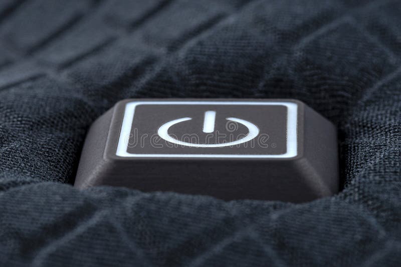 Macro shot of a plastic button with a white power symbol, sewn into modern clothing. Macro shot of a plastic button with a white power symbol, sewn into modern clothing