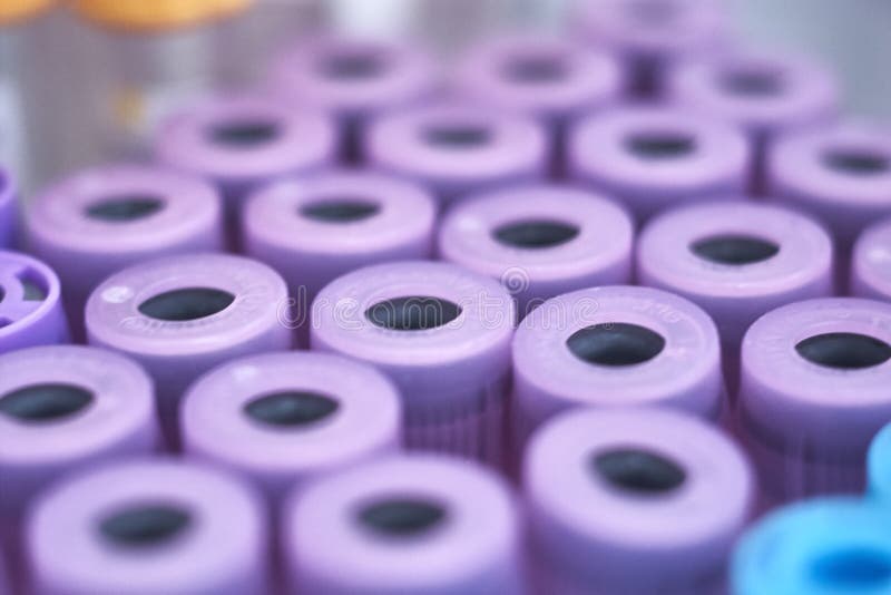 Macro Of Test Tubes With Purple Top, Against A Gradient Of White