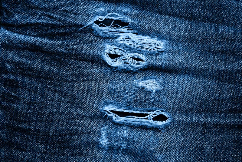 Macro Texture of Jeans Hole and Threads Colored in Classic Blue Trendy